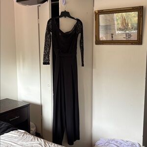 Elegant Black Lace Jumpsuit, A dramatic side slit in the pant leg.